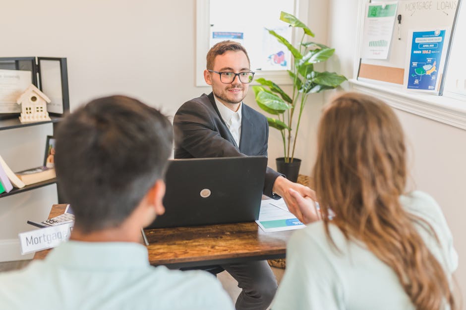 A mortgage broker meeting clients in an office, discussing agreements and loans